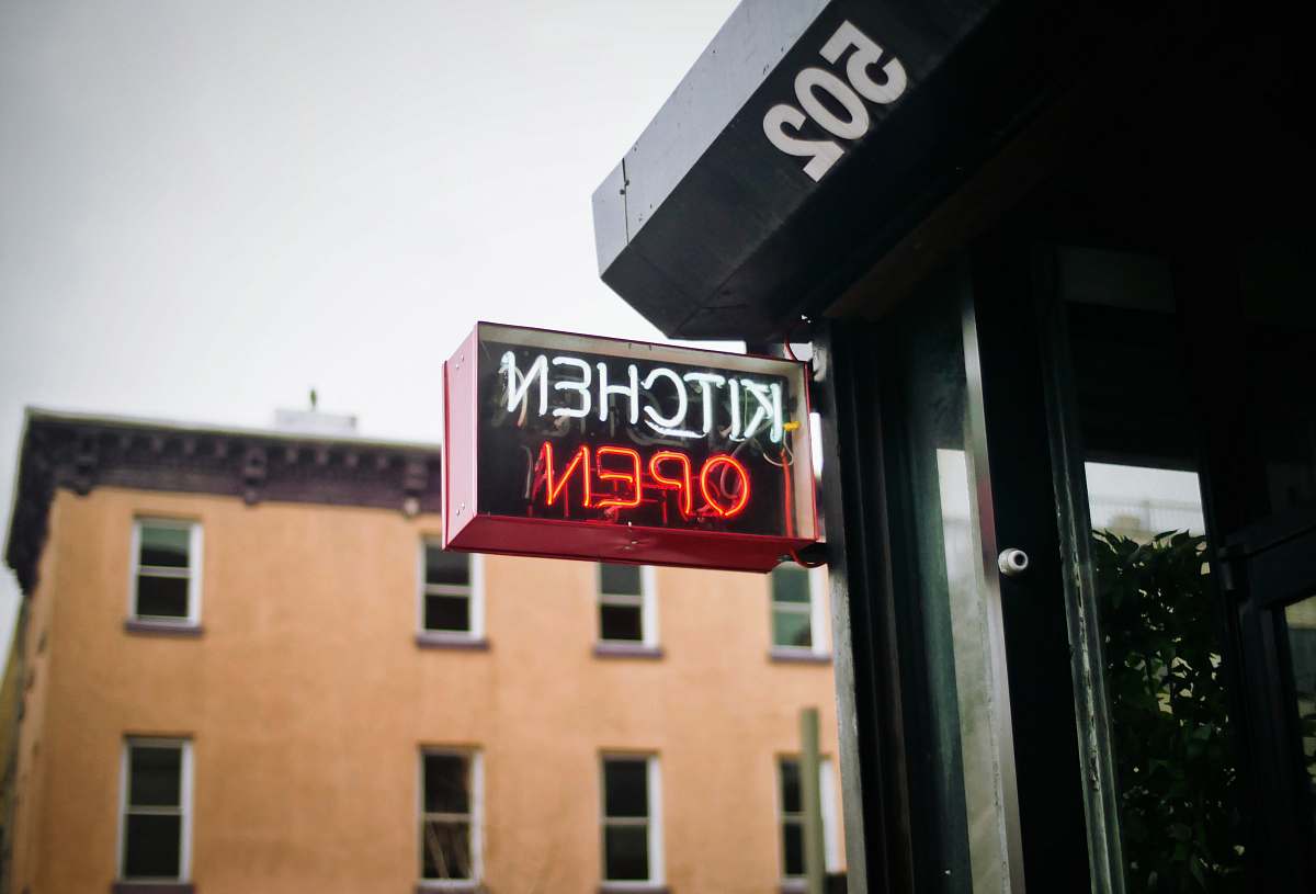 neon white and red neon lighted kitchen open signage during daytime williamsburg